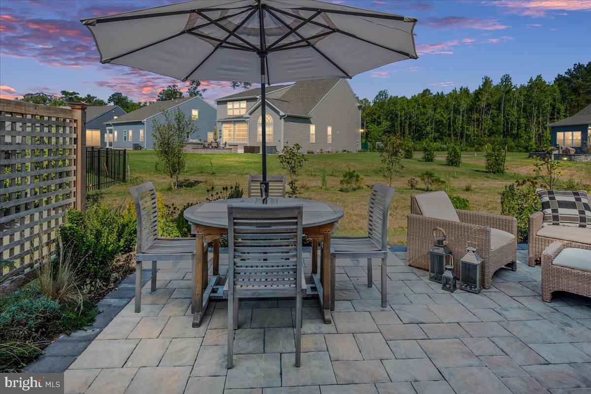 65 Old Forge Drive Ocean View, DE 19970 - Photo 55 of 69 a view of a patio with a table chairs and a fire pit