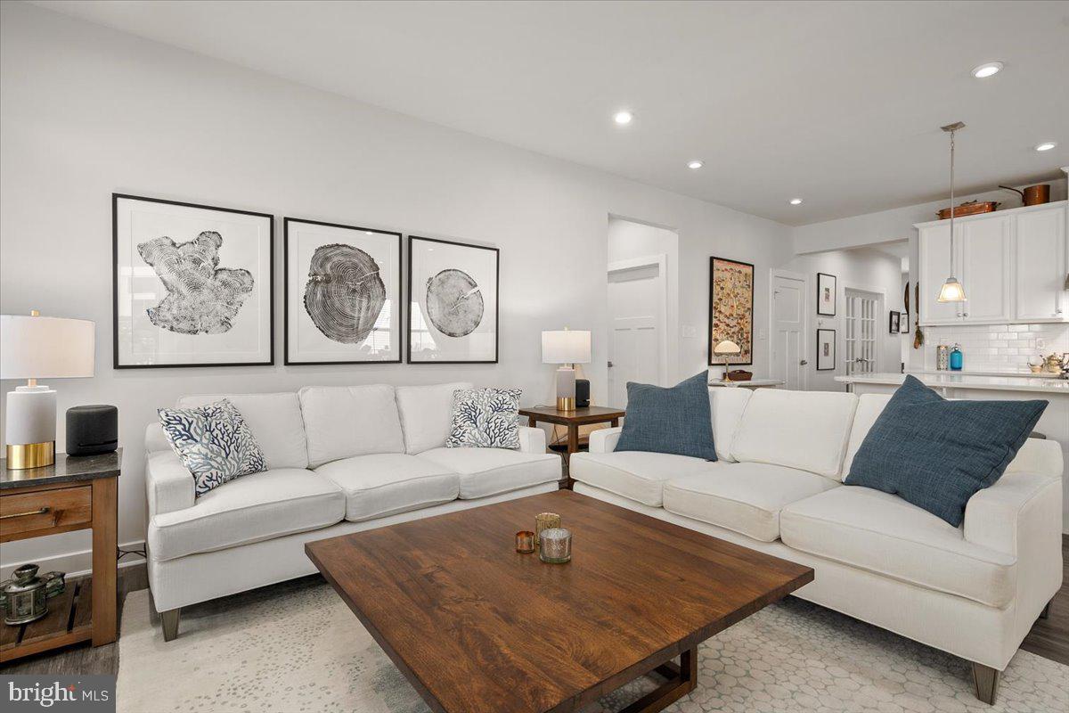 65 Old Forge Drive Ocean View, DE 19970 - Photo 8 of 69 a living room with furniture and paintings on the wall