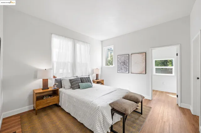 a bedroom with a bed and wooden floor