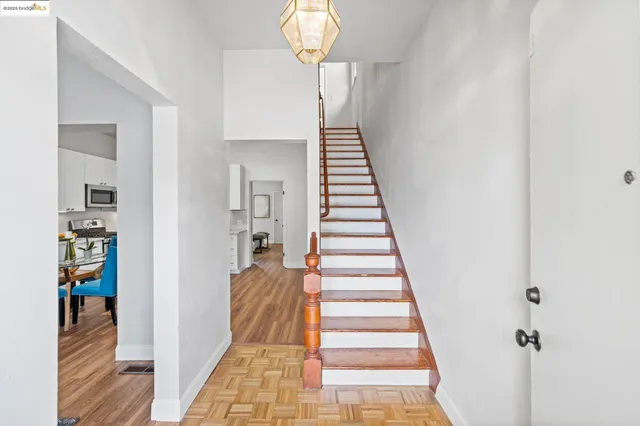 a view of a hallway with wooden floor and entryway
