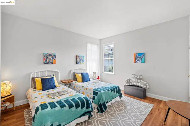 a bedroom with two beds and a window