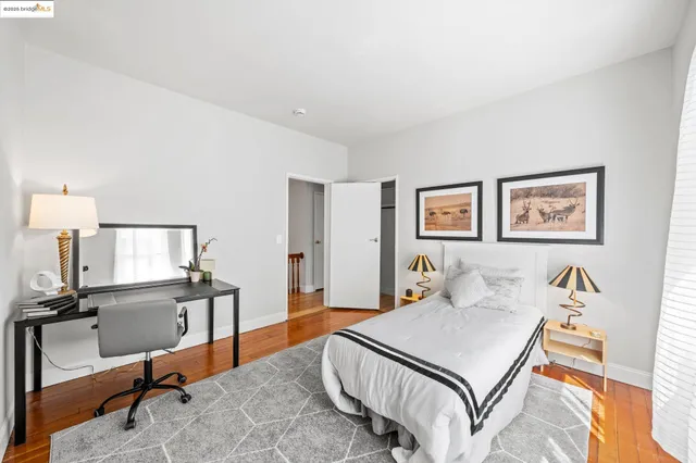 a bedroom with a bed and a desk