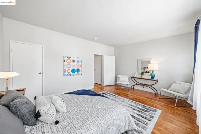 a bedroom with a bed and wooden floor