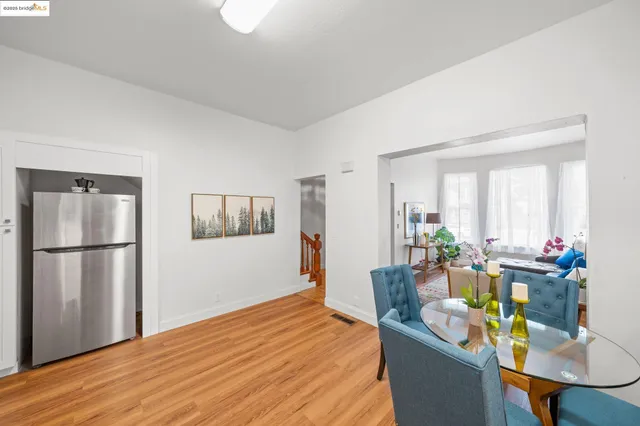 a dining room with furniture and wooden floor