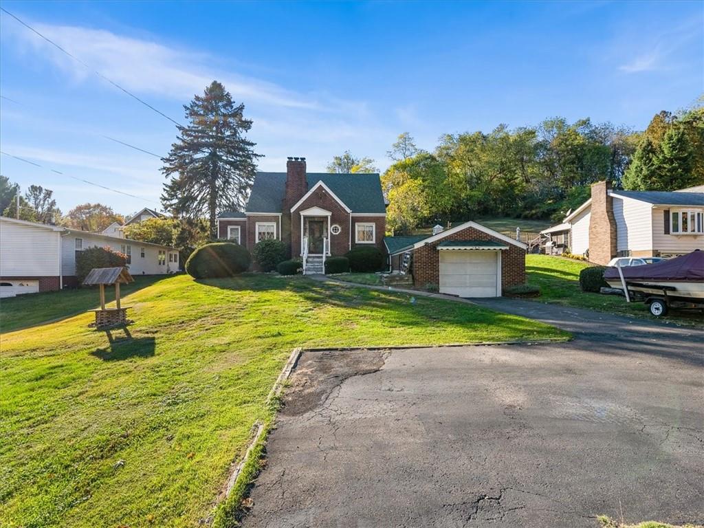 a view of house with garden and tall trees