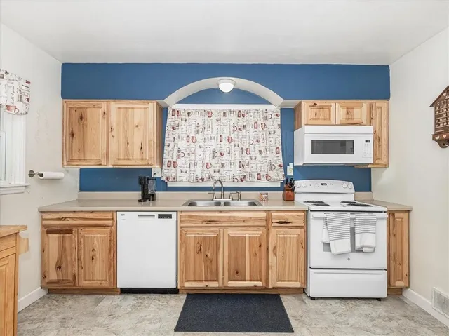 a kitchen with a stove oven and white cabinets