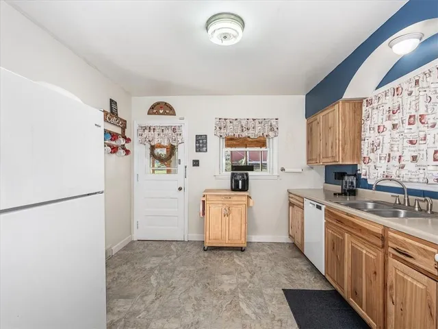 a kitchen with a refrigerator and a sink