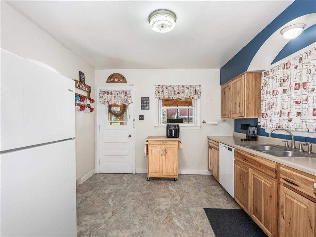 185 Highway 68 Rochester, PA 15074 - Photo 13 of 29 a kitchen with a refrigerator and a sink