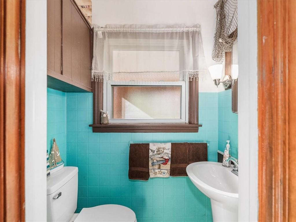 185 Highway 68 Rochester, PA 15074 - Photo 14 of 29 a bathroom with a toilet sink and mirror