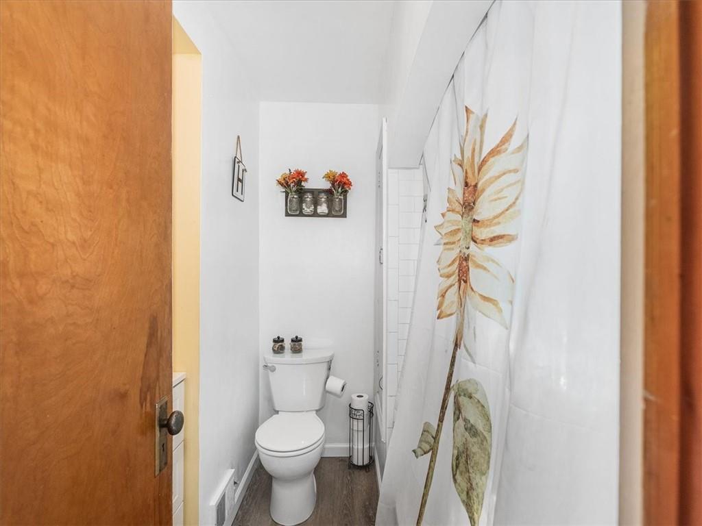 185 Highway 68 Rochester, PA 15074 - Photo 17 of 29 a bathroom with a toilet and a shower curtain