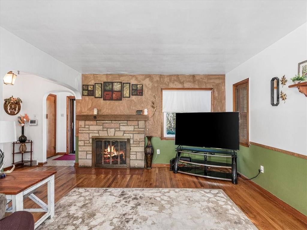 185 Highway 68 Rochester, PA 15074 - Photo 5 of 29 a living room with furniture a flat screen tv and a fireplace