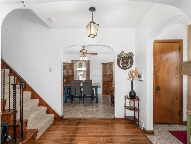 a view of a dining room with furniture wooden floor and a chandelier