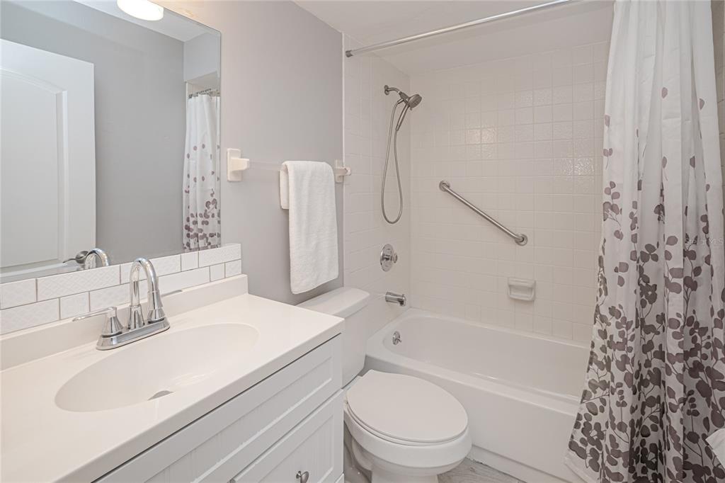 24540 Harbor View Road, Unit D3 Punta Gorda, FL 33980 - Photo 14 of 33 a bathroom with a sink toilet vanity and shower