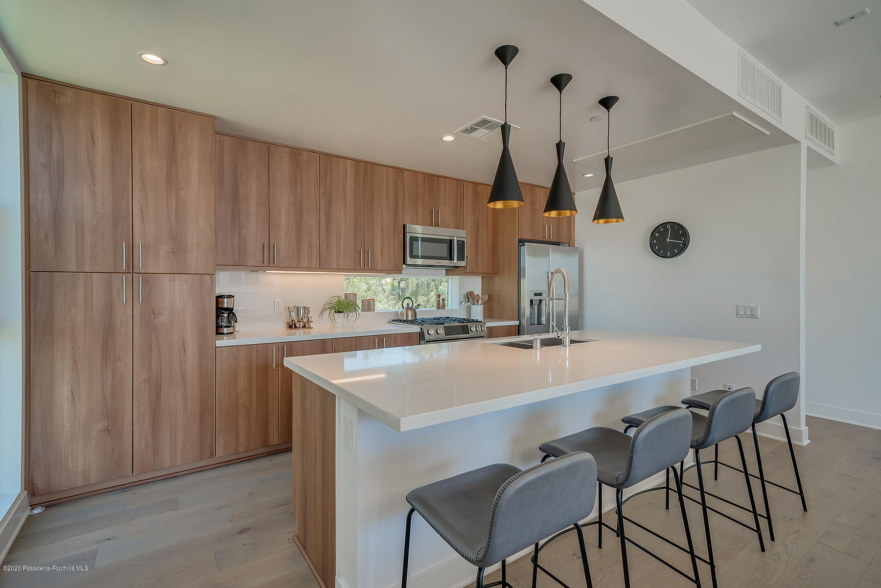 a kitchen with stainless steel appliances a table chairs and chandelier