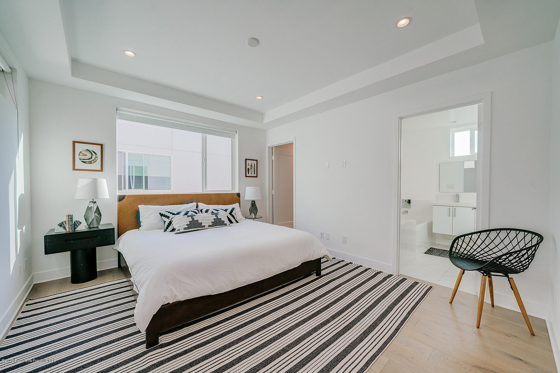 855 Hyperion Avenue Los Angeles, CA 90029 - Photo 11 of 35 a bedroom with a bed and a chandelier