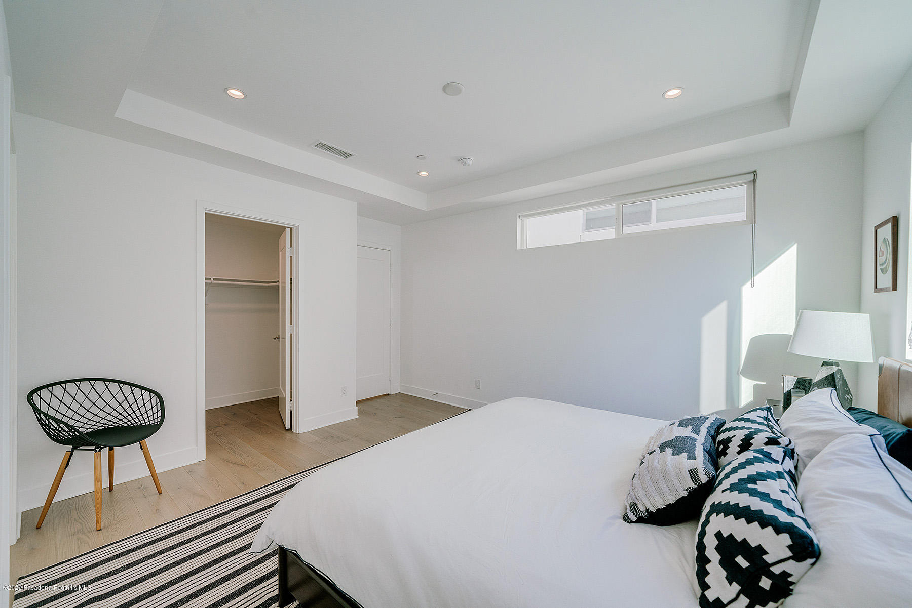 855 Hyperion Avenue Los Angeles, CA 90029 - Photo 13 of 35 a bedroom with a bed and a chandelier