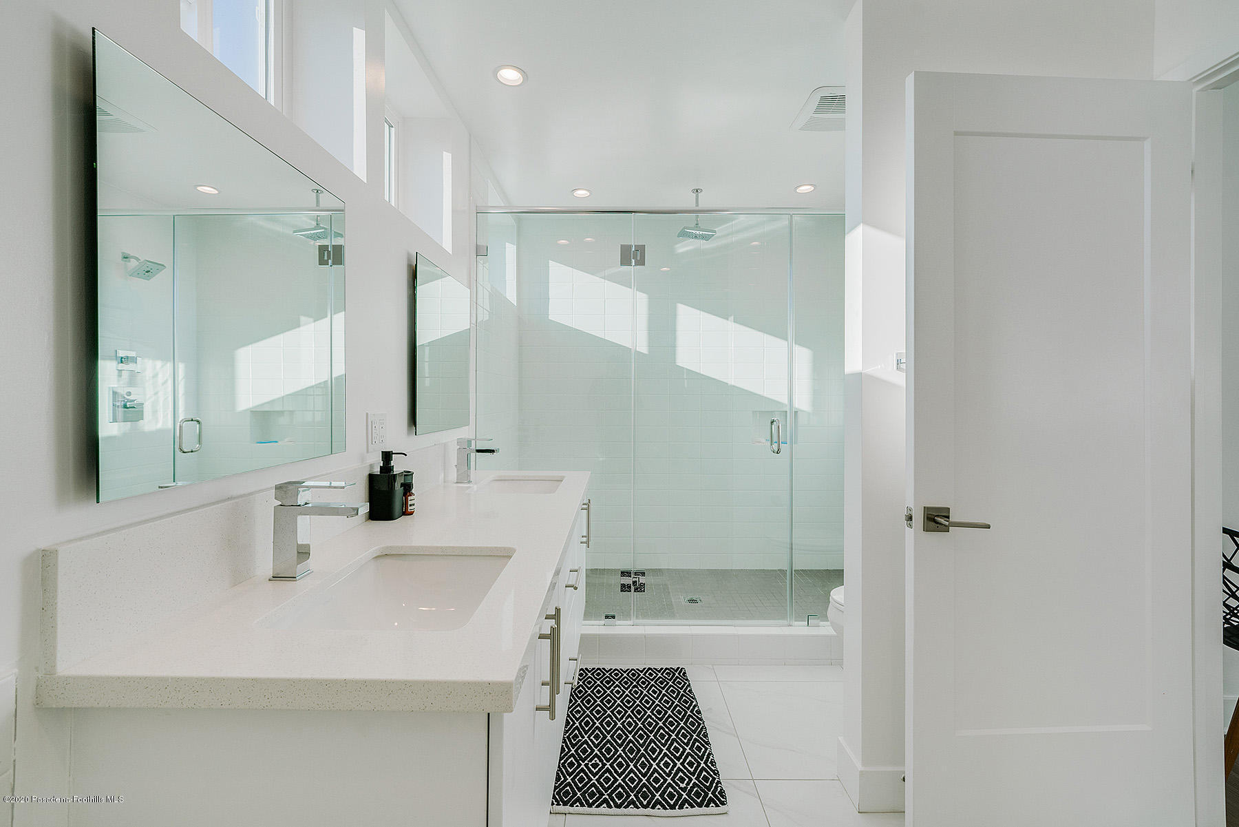 855 Hyperion Avenue Los Angeles, CA 90029 - Photo 15 of 35 a bathroom with a sink a toilet and a mirror