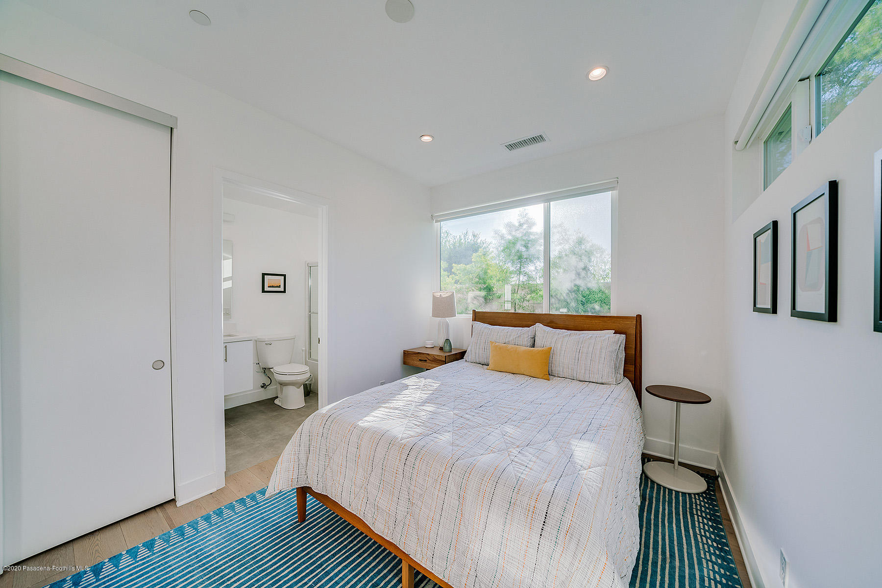 855 Hyperion Avenue Los Angeles, CA 90029 - Photo 23 of 35 a bedroom with a bed and wooden floor