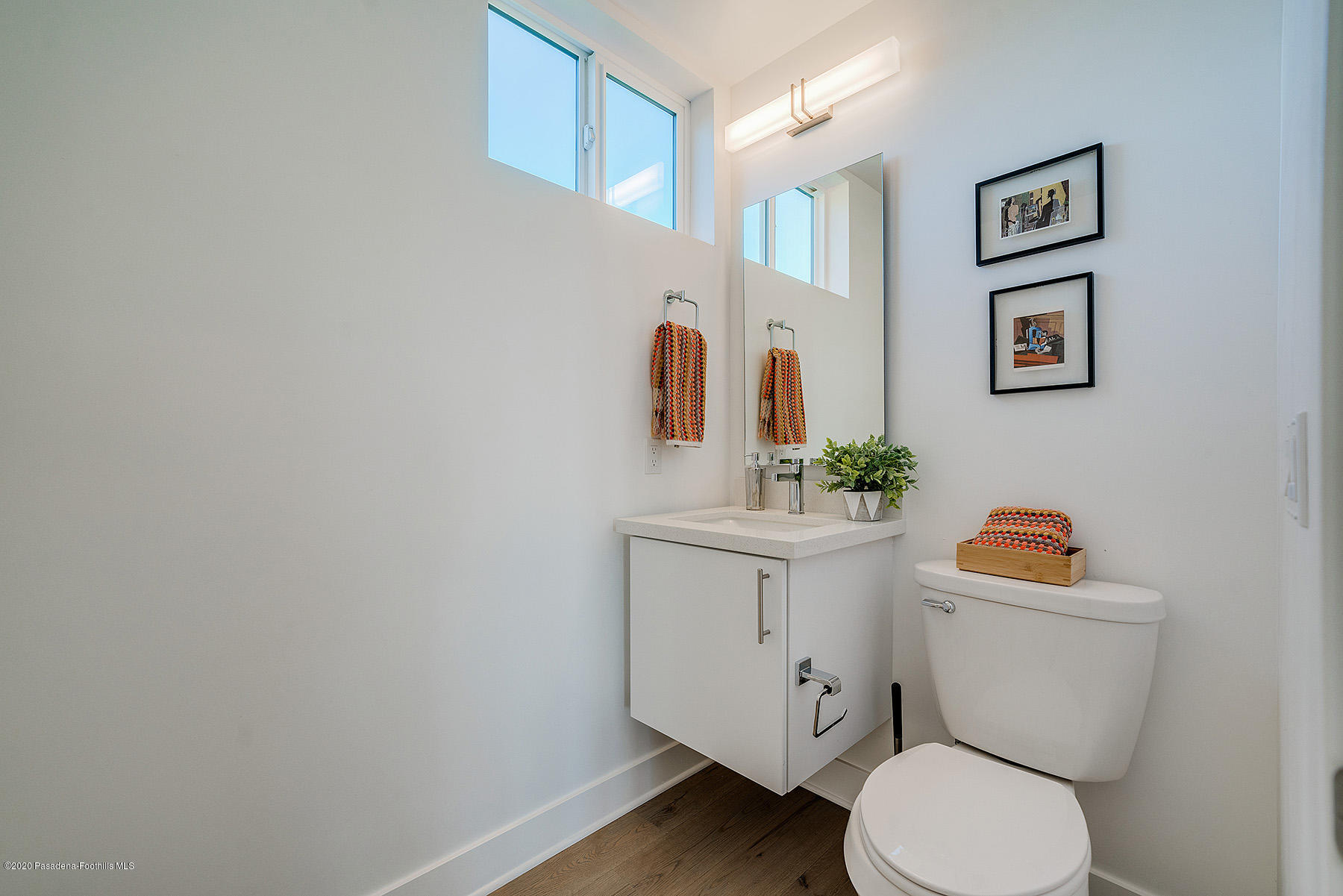 855 Hyperion Avenue Los Angeles, CA 90029 - Photo 28 of 35 a white toilet sitting next to a bathroom sink