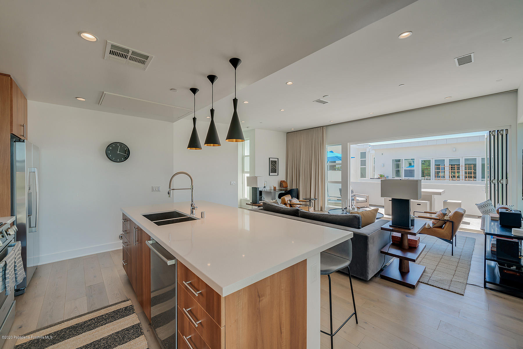 855 Hyperion Avenue Los Angeles, CA 90029 - Photo 5 of 35 a kitchen with a sink a stove and chairs