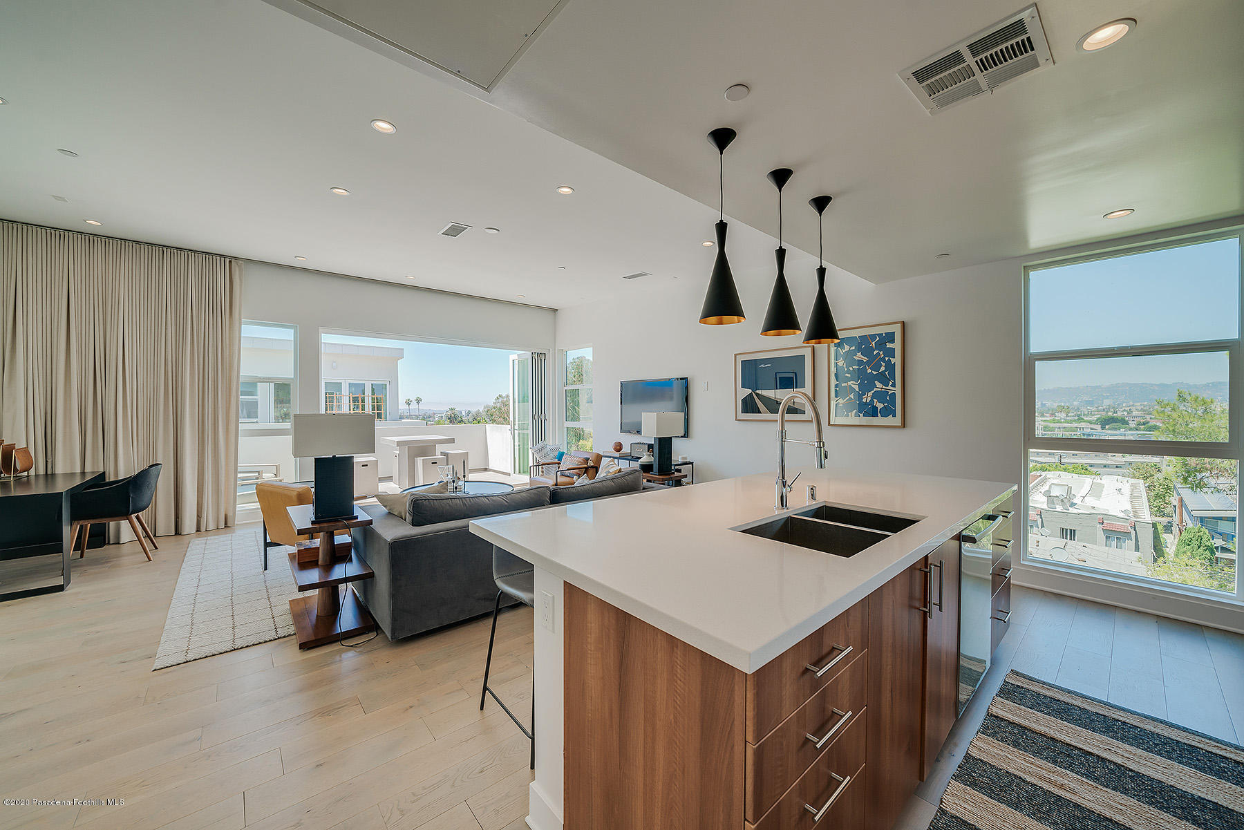 855 Hyperion Avenue Los Angeles, CA 90029 - Photo 9 of 35 a kitchen that has a lot of cabinets a sink and wooden floor