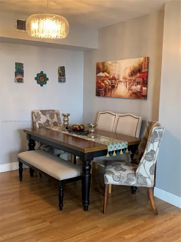 a kitchen with a refrigerator and a stove top oven
