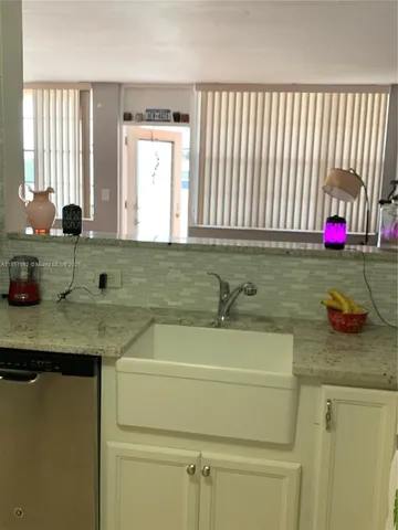 a view of a chairs and table in patio with a yard