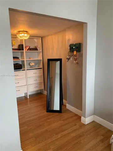 an empty room with wooden floor and closet