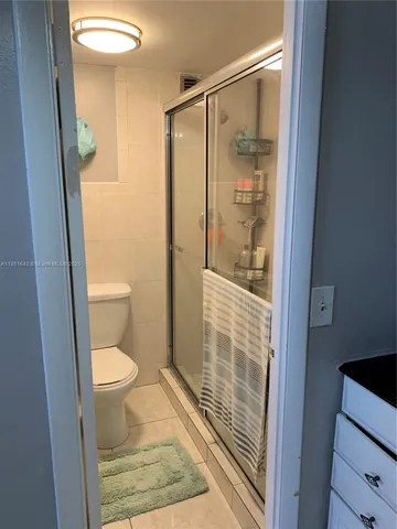 a bathroom with a toilet and a shower