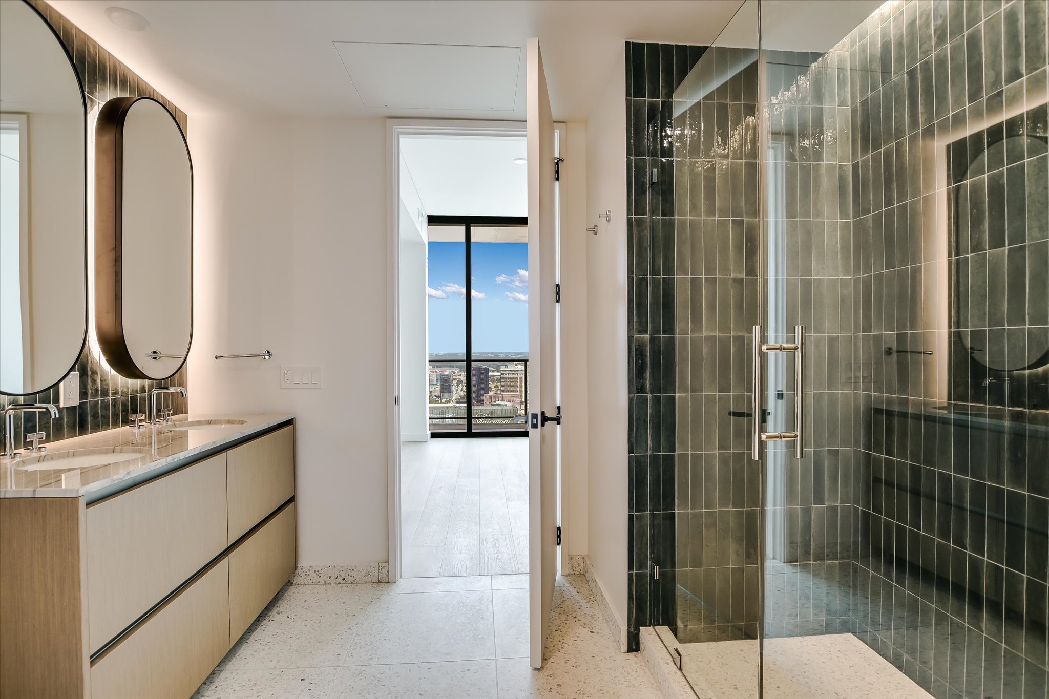 610 Davis Street, Unit 4704 Austin, TX 78701 - Photo 17 of 40 a bathroom with a mirror a shower and a sink