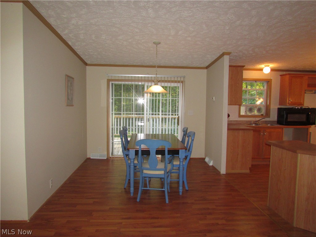 1220 Way Road Rome, OH 44085 - Photo 10 of 25 The dining room opens onto the back deck. Enjoy your coffee on the deck in the mornings, overlooking the scenic backyard!