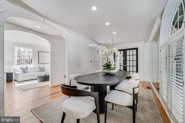 a living room with furniture a fireplace and a large window