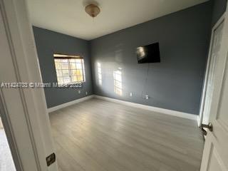 3390 Northeast 11th Drive, Unit 3390 Homestead, FL 33033 - Photo 11 of 20 an empty room with windows and fireplace