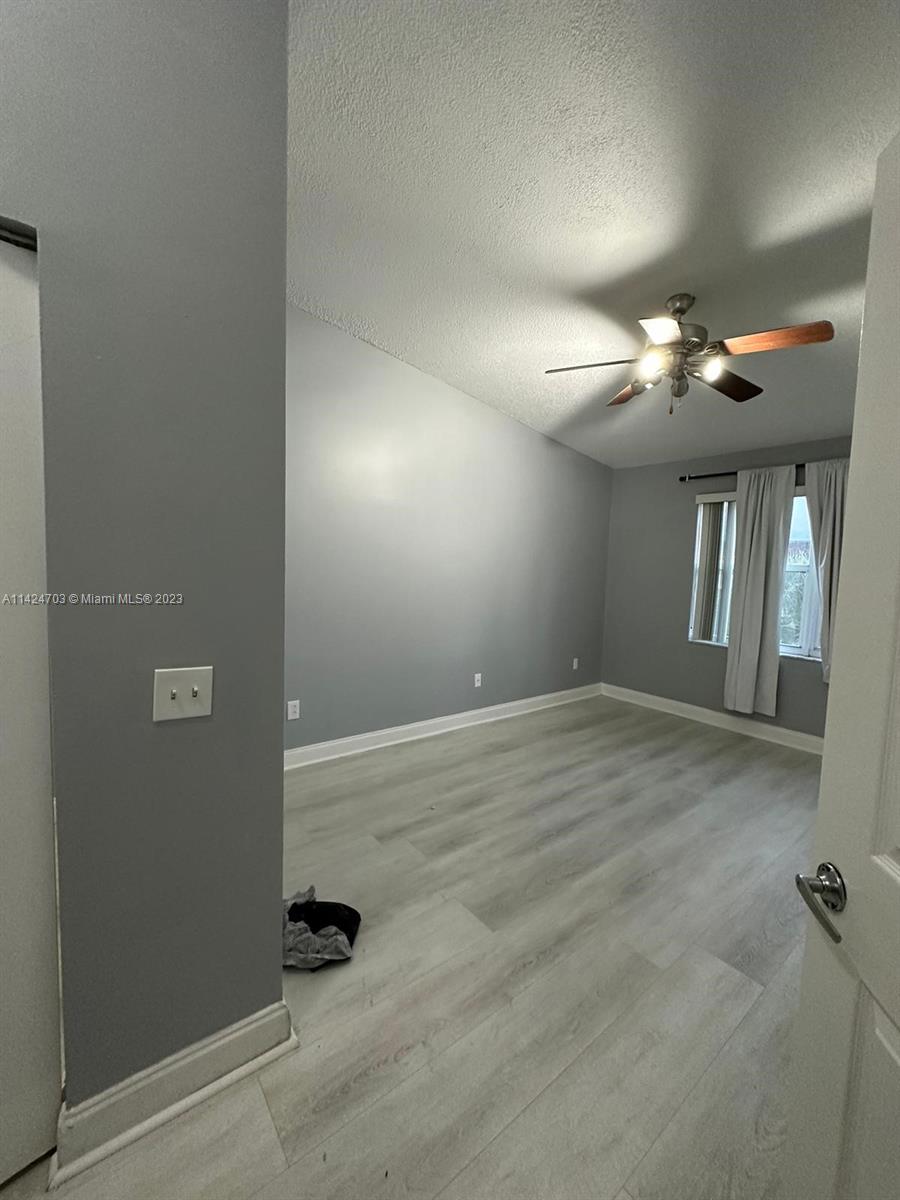 3390 Northeast 11th Drive, Unit 3390 Homestead, FL 33033 - Photo 15 of 20 an empty room with windows and fan