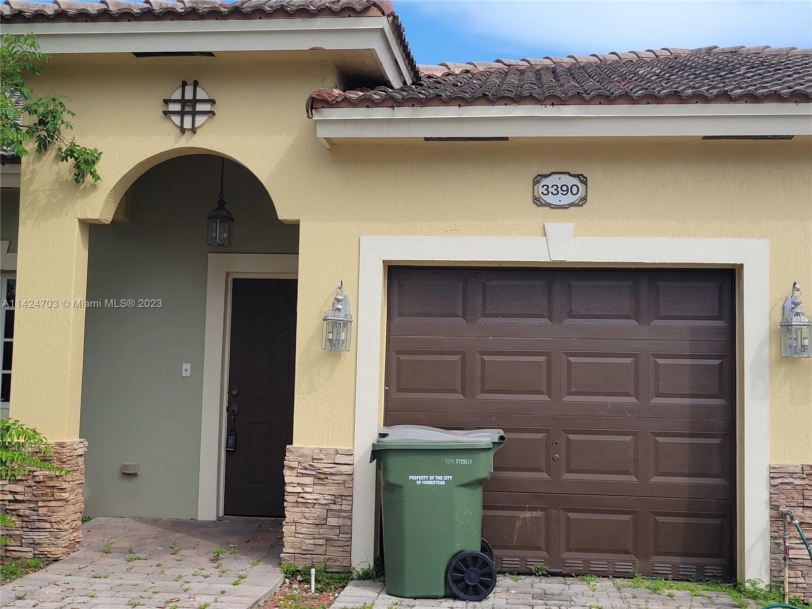 3390 Northeast 11th Drive, Unit 3390 Homestead, FL 33033 - Photo 3 of 20 a front view of a house with garage
