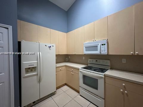 3390 Northeast 11th Drive, Unit 3390 Homestead, FL 33033 - Photo 6 of 20 a kitchen with a refrigerator sink and stove top oven