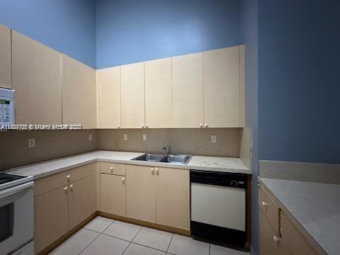 3390 Northeast 11th Drive, Unit 3390 Homestead, FL 33033 - Photo 7 of 20 a kitchen with a sink and cabinets