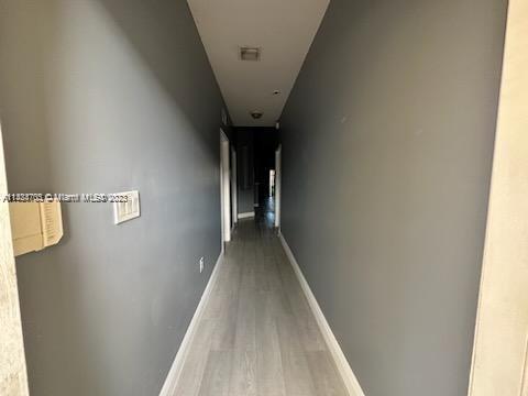 3390 Northeast 11th Drive, Unit 3390 Homestead, FL 33033 - Photo 10 of 20 a view of a hallway with wooden floor
