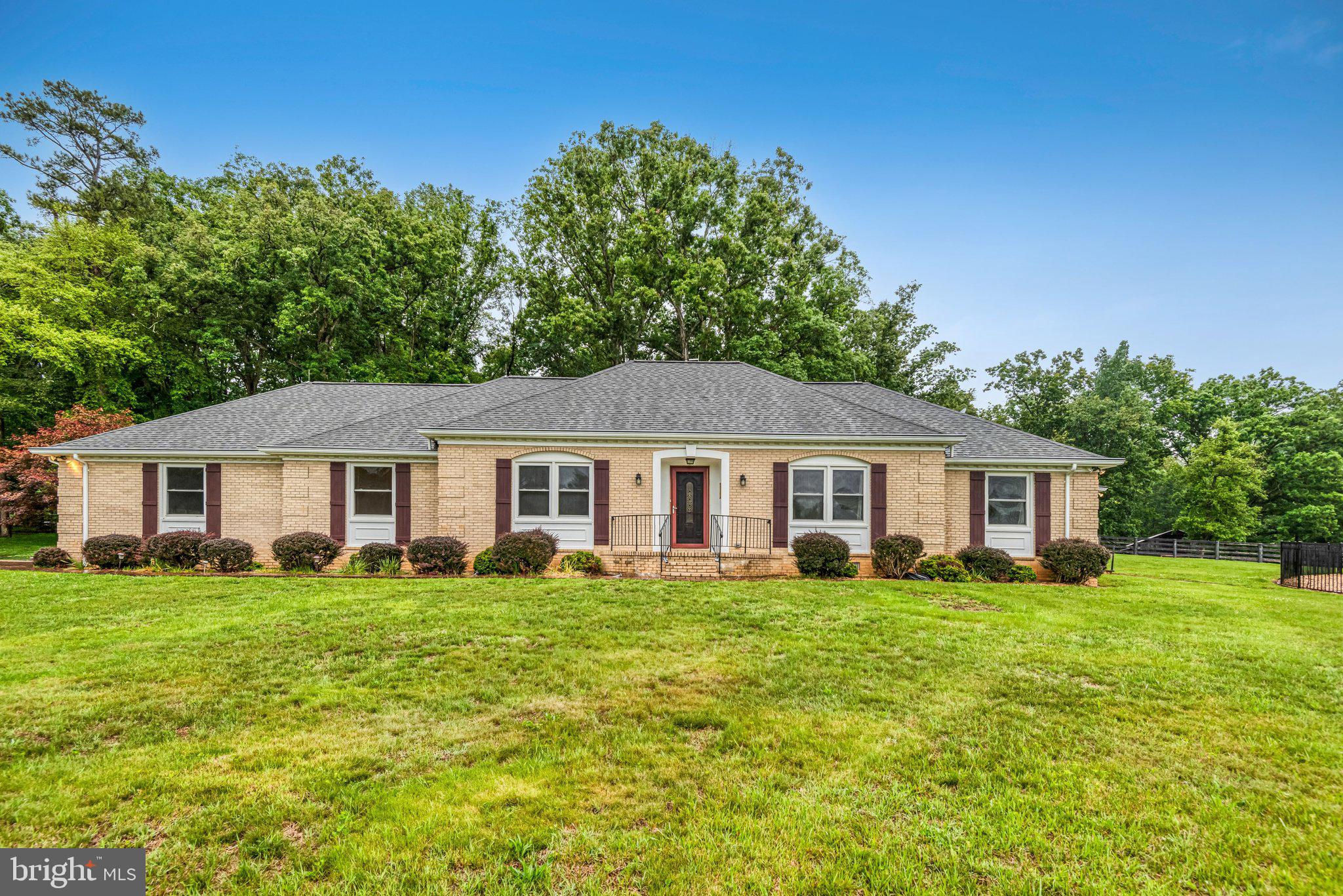 7961 Leeds Manor Road Marshall, VA 20115 - Photo 3 of 40 a view of a house with a big yard and large trees