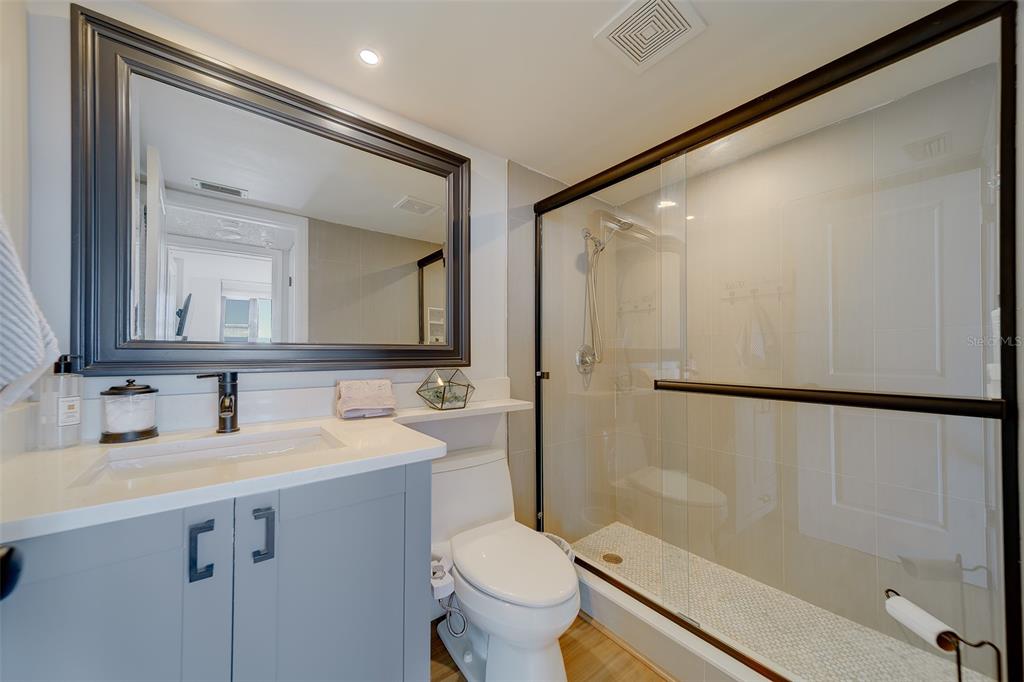255 Dolphin Point, Unit 802 Clearwater Beach, FL 33767 - Photo 18 of 41 a bathroom with a double vanity sink mirror and toilet