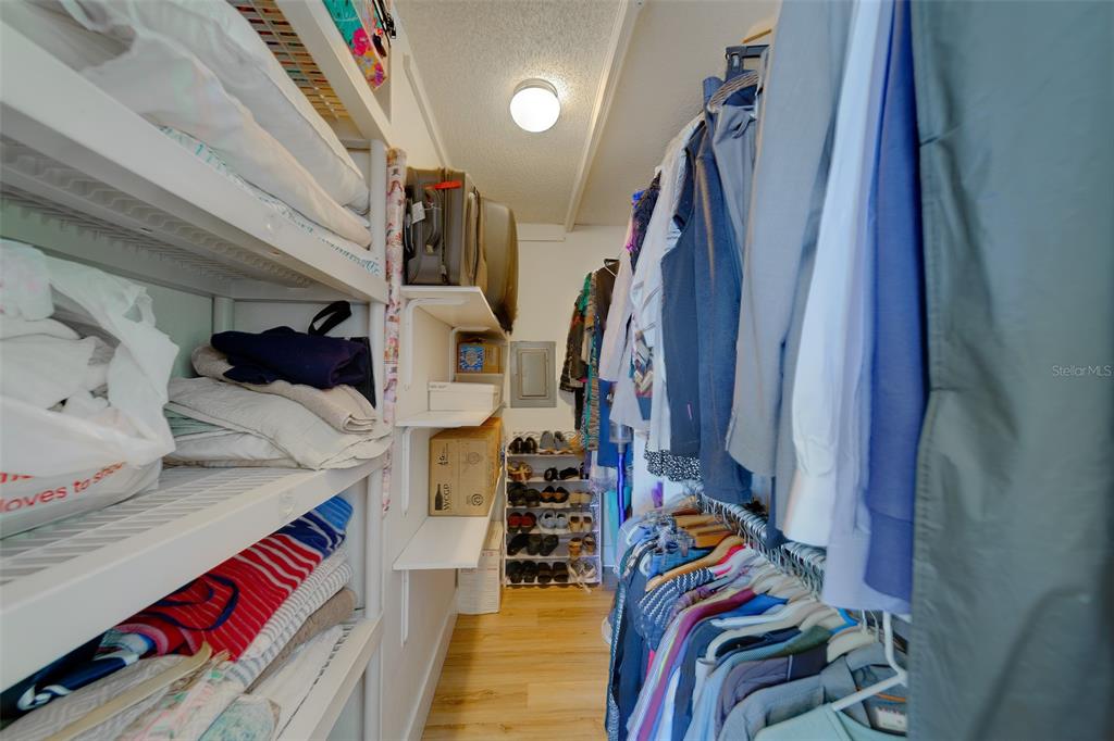 255 Dolphin Point, Unit 802 Clearwater Beach, FL 33767 - Photo 22 of 41 a view of walk in closet with clothes and shoes
