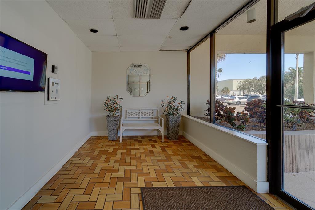 255 Dolphin Point, Unit 802 Clearwater Beach, FL 33767 - Photo 27 of 41 a room with wooden floor and a window