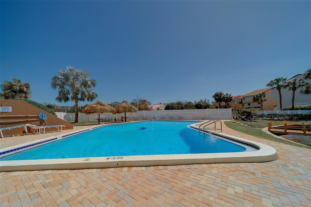 255 Dolphin Point, Unit 802 Clearwater Beach, FL 33767 - Photo 32 of 41 a view of a swimming pool and outdoor space