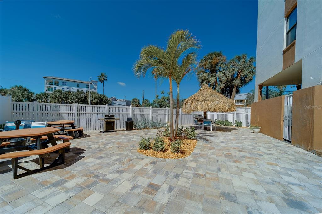 255 Dolphin Point, Unit 802 Clearwater Beach, FL 33767 - Photo 33 of 41 a view of a backyard with couches table and chairs