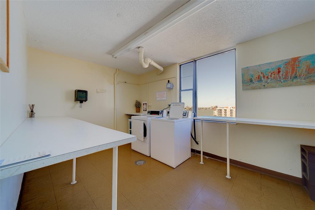 255 Dolphin Point, Unit 802 Clearwater Beach, FL 33767 - Photo 35 of 41 a room with table and chair