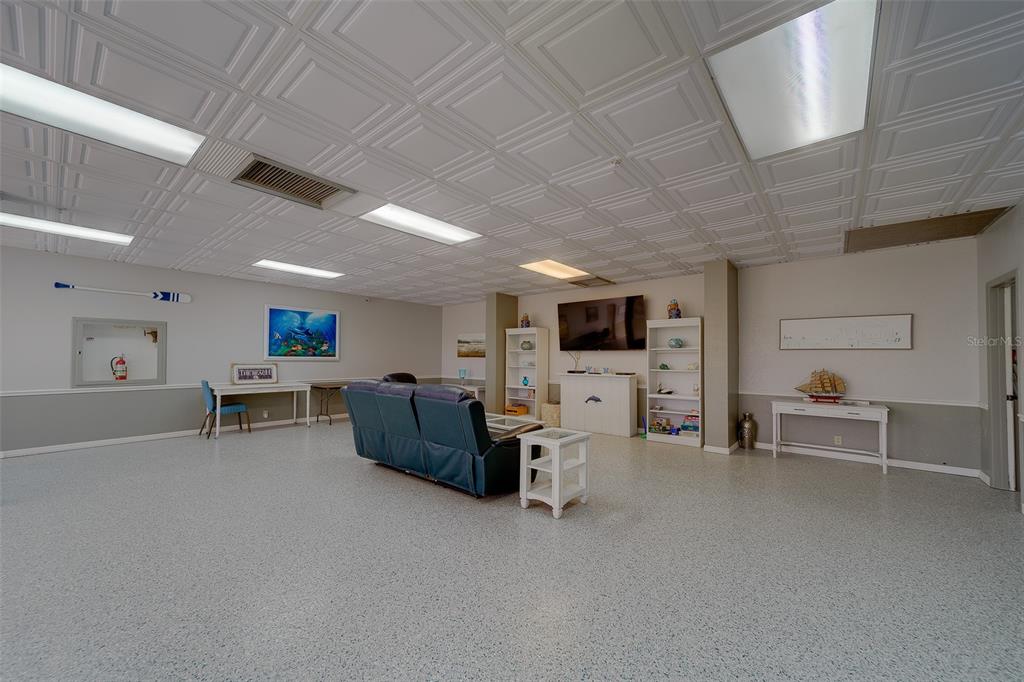 255 Dolphin Point, Unit 802 Clearwater Beach, FL 33767 - Photo 39 of 41 a living room with furniture and a flat screen tv