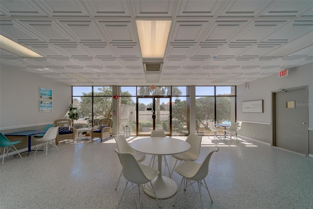 255 Dolphin Point, Unit 802 Clearwater Beach, FL 33767 - Photo 40 of 41 a dining room with furniture and a floor to ceiling window