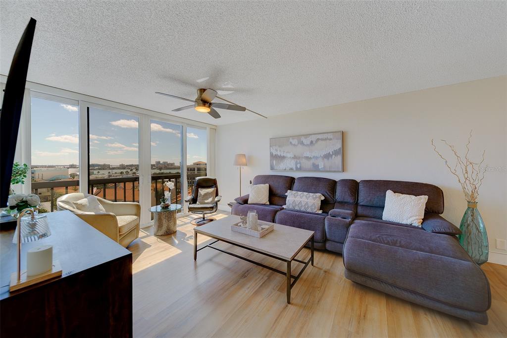255 Dolphin Point, Unit 802 Clearwater Beach, FL 33767 - Photo 5 of 41 a living room with furniture and large window