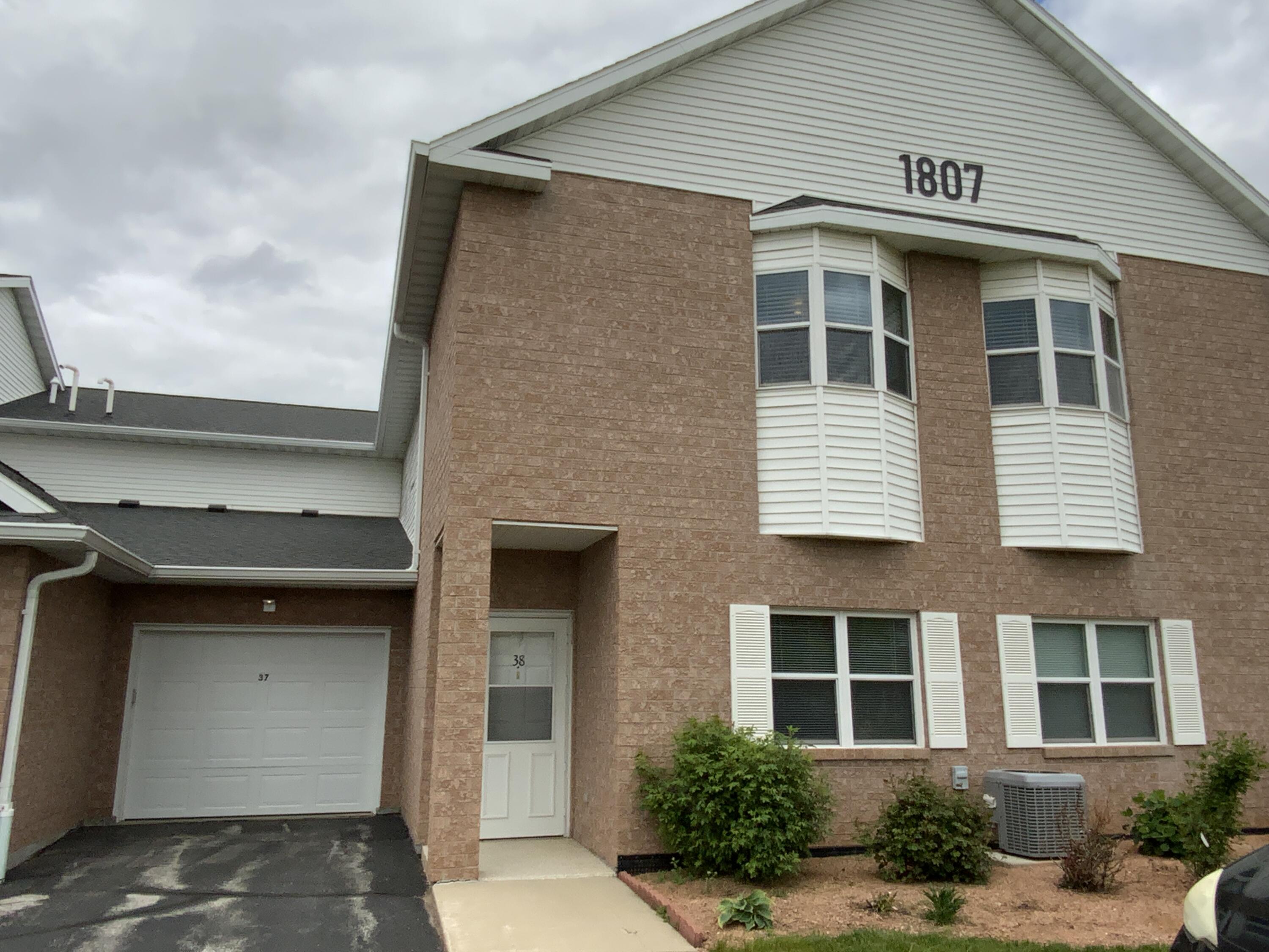 1807 Ridgeway Drive, Unit 38 De Pere, WI 54115 - Photo 36 of 39 front of condo with rose bushes