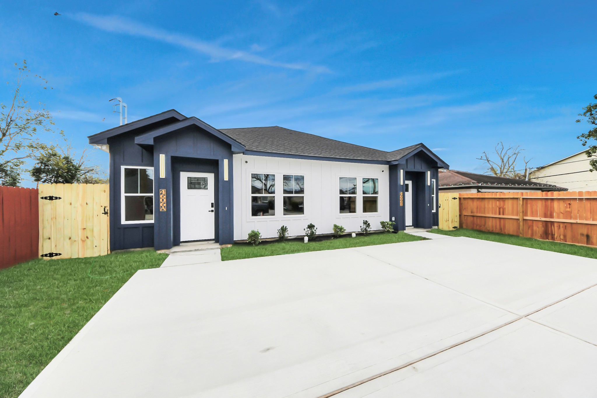 4606 Mallow Street Houston, TX 77051 - Photo 1 of 31 Modern, single-story home with a fresh blue and white exterior. It features a spacious driveway, neatly landscaped front yard, and a welcoming entrance. The property is enclosed by a wooden fence, offering privacy and a contemporary curb appeal.